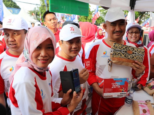 Direktur Consumer Service Telkom Siti Choiriana (kedua dari kiri), dan Direktur Human Capital Management Telkom Edi Witjara (paling kiri) berbelanja produk kerajinan di UKM Binaan Telkom
